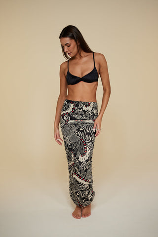 Front pose #1 of Miyajima in Caspian Cover-up as a skirt paired with Black Depth Meridian Underwire Bikini Top