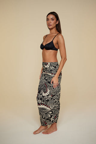 Quarter pose #1 of Miyajima in Caspian Cover-up as a skirt paired with Black Depth Meridian Underwire Bikini Top
